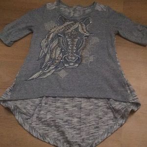 A shirt with a design of a horse on it.